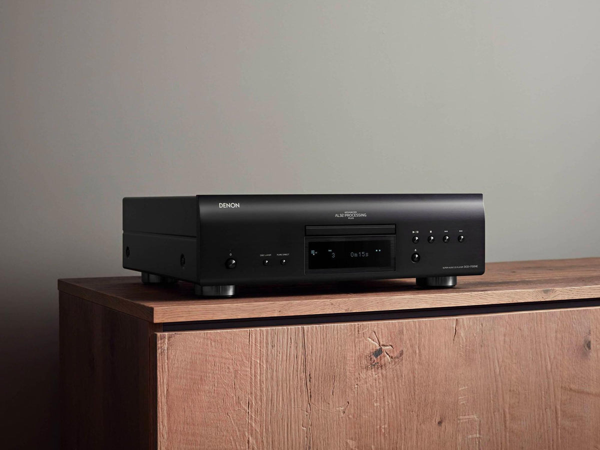 Denon DCD-1700NE CD/SACD player: black player on a wooden cabinet, angled view