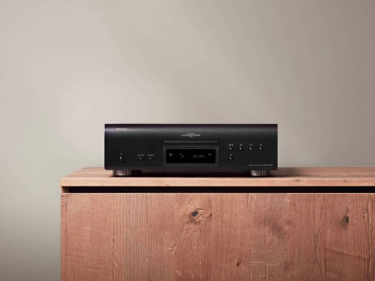 Denon DCD-1700NE CD/SACD player: black player on a wooden cabinet, front view