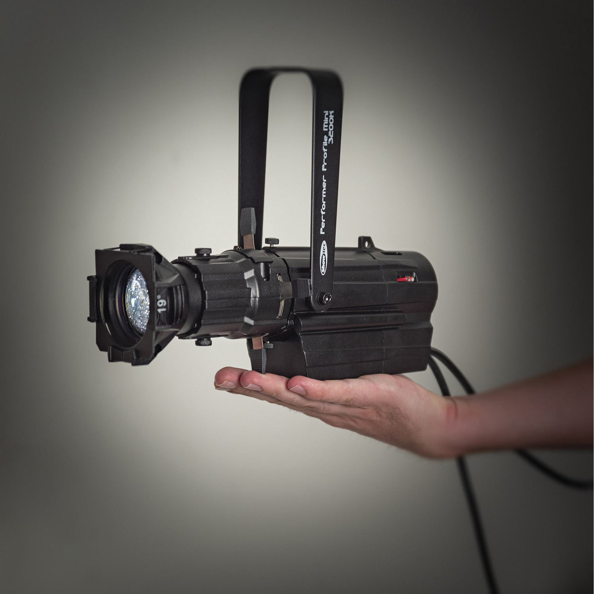 Showtec Performer Profile Mini, compact fixture with optional optics held in a hand